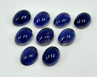 May include: Ten oval-shaped, dark blue gemstones. The gemstones are smooth and polished, with a slight sparkle.