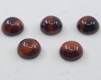 May include: Five round, red and brown tiger's eye cabochons. The cabochons are smooth and polished.