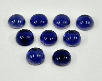 May include: Ten round, dark blue cabochon gemstones. The gemstones are smooth and polished.