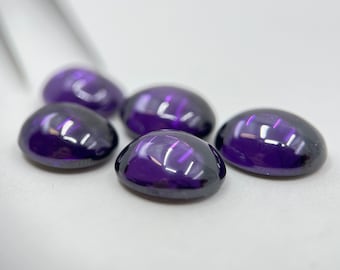 May include: Five oval-shaped, deep purple gemstones with a glossy finish.