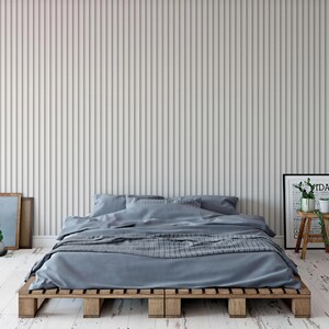 a modern bedroom with a bed, wooden bed frame, and a minimalist design.