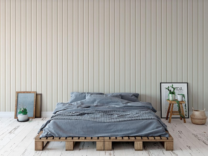 a modern bedroom with a bed, wooden bed frame, and a minimalist decor.