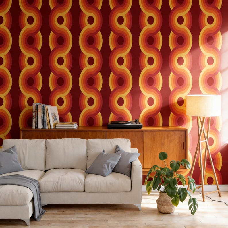 a living room with a white sofa, a wooden cabinet, a potted plant, and a record player on a wooden stand. The walls are covered in a vibrant, retro-style wallpaper with a repeating pattern of circles in shades of red, orange, and yellow.