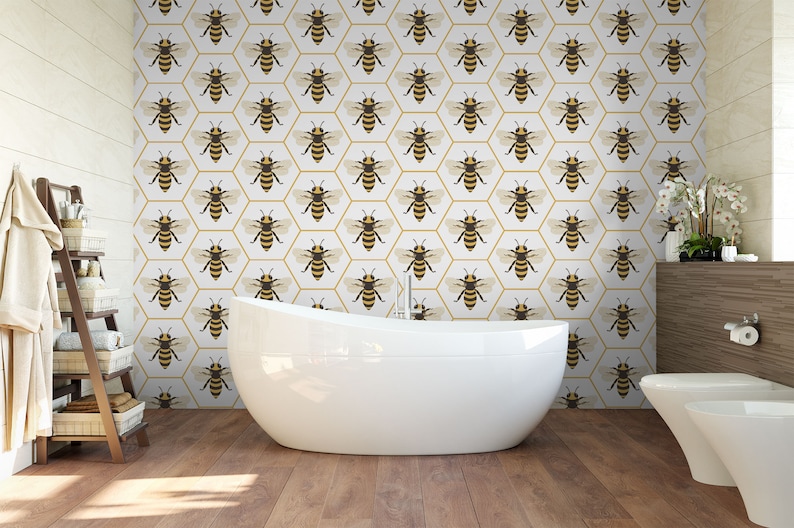 May include: A white bathroom with a bathtub and a toilet. The walls are covered in wallpaper featuring a pattern of bees in hexagonal cells. The wallpaper is white with gold accents.