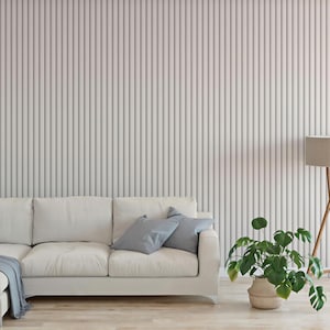 a modern living room with a white sofa, a potted plant, and a floor lamp.