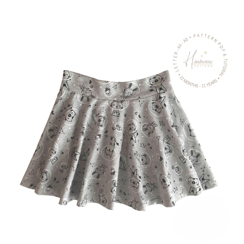 May include: A grey skater skirt featuring a repeating black line art pattern of animals in space helmets, stars, and geometric shapes. The text in the circular logo reads Handsome Pattern, Letter, A4, A0, 12 Months, 11 Years.