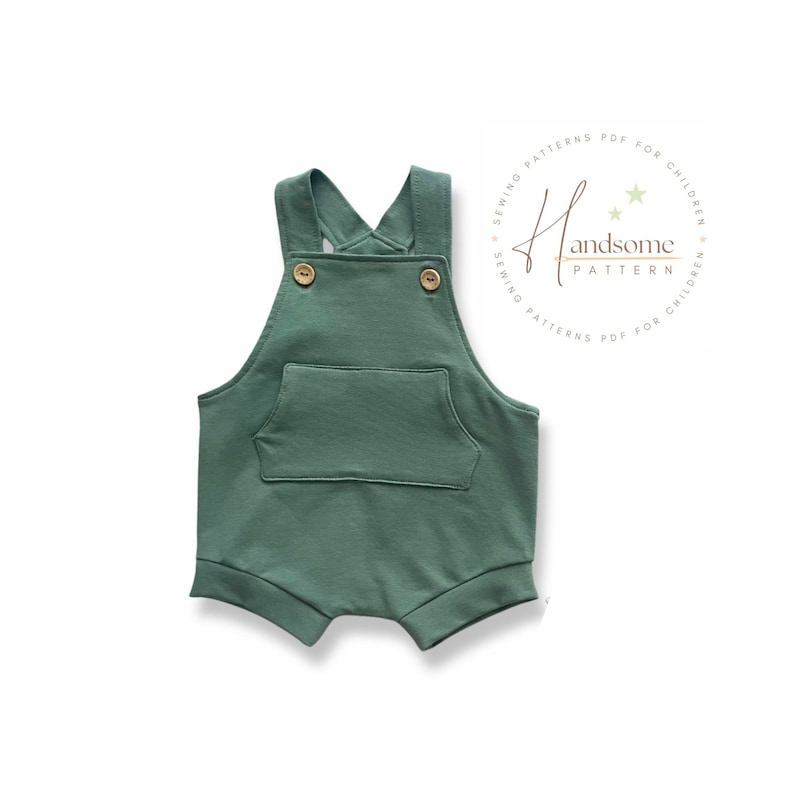 May include: A green romper with a front pocket and wooden buttons. The straps cross at the back. The romper is designed for children. The text "Handsome Pattern" is in a circle on the right side.
