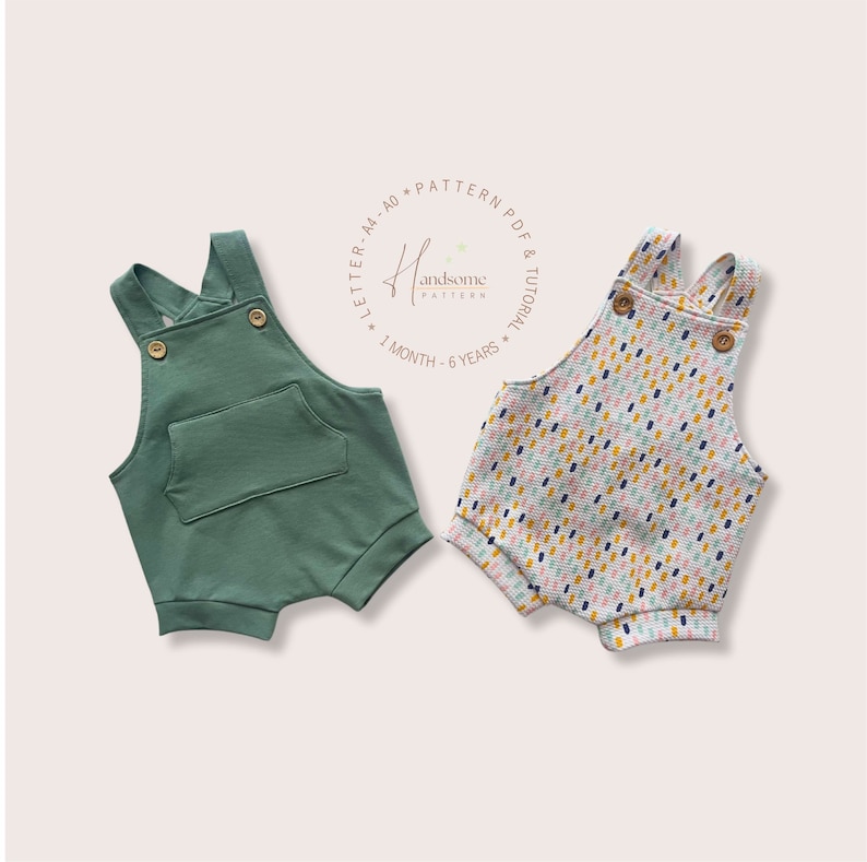 May include: Two baby rompers. One is a solid green with a front pocket and wooden buttons. The other is patterned with a white background and colourful dashes. Both have cross-back straps and rolled hems. The text "Handsome Pattern" is in a circle.