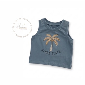 May include: A slate blue sleeveless tank top featuring a graphic of a tan palm tree and the text ALOHA STATE printed in dark blue. To the left, a circular logo includes the text Handsome Pattern, Pattern PDF & Tutorial, and Newborn-3 Years.