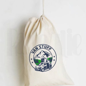 May include: A white canvas drawstring bag with a blue and green logo that says "Van Stuff" and features a mountain scene with a camper van.