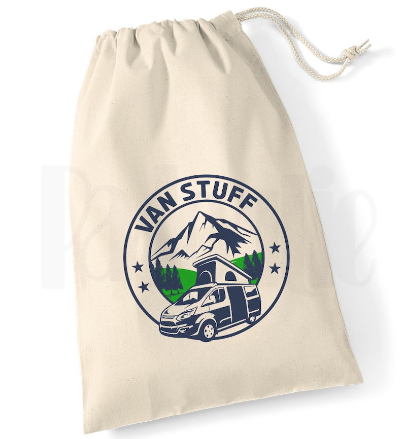 May include: A white canvas drawstring bag with a blue and green logo that says "VAN STUFF" and features a mountain, trees, and a camper van.