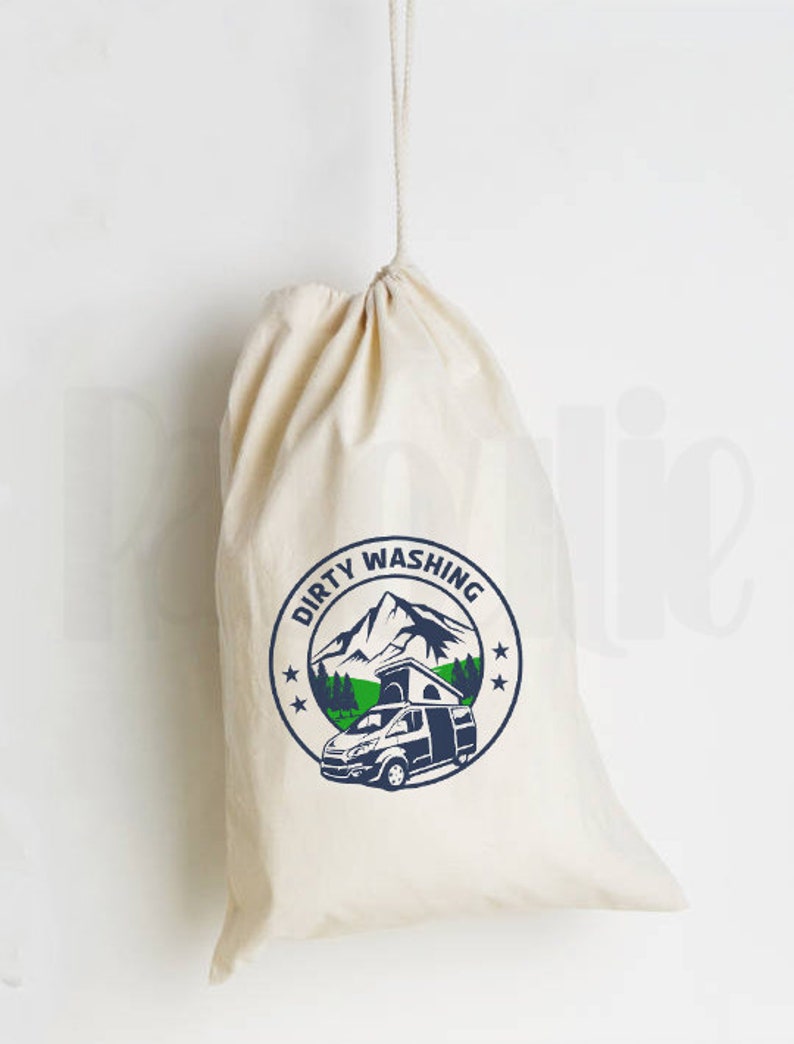 May include: A white canvas drawstring bag with the text "Dirty Washing" in blue and a graphic of a camper van in front of a mountain range.