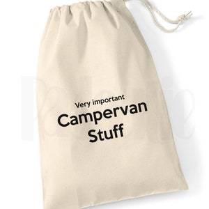 May include: A white canvas drawstring bag with the text "Very important Campervan Stuff" printed in black.
