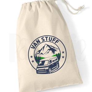 May include: A white canvas drawstring bag with a blue and green logo that says "VAN STUFF" with a mountain and a van in the design.