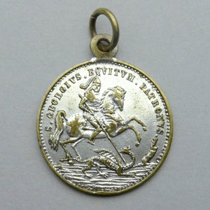 Saint George slays the dragon. Antique Large Pendant.