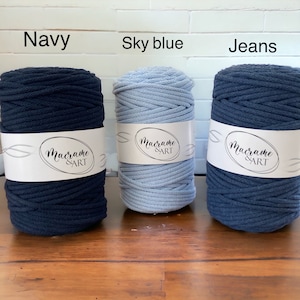 May include: Three spools of cotton rope in navy, sky blue, and jeans colors. Each spool has a white label with the text "Macrame & ART" printed on it.