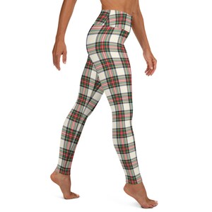 May include: White yoga leggings with a red, green, and white plaid pattern. The leggings are high-waisted and have a fitted silhouette.