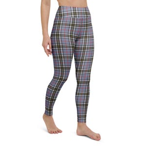 May include: High-waisted leggings with a blue, red, black, white, and yellow plaid pattern. The leggings are form-fitting and made of a stretchy material. The plaid design is a classic pattern.