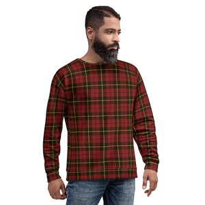 May include: A long-sleeved sweatshirt with a traditional plaid design in red, black, and yellow. The crew neck top is made of a soft fabric. The plaid pattern is a classic design, suitable for casual wear. The garment is a comfortable fit.