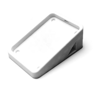 May include: White plastic phone stand with a raised edge and a triangular base.