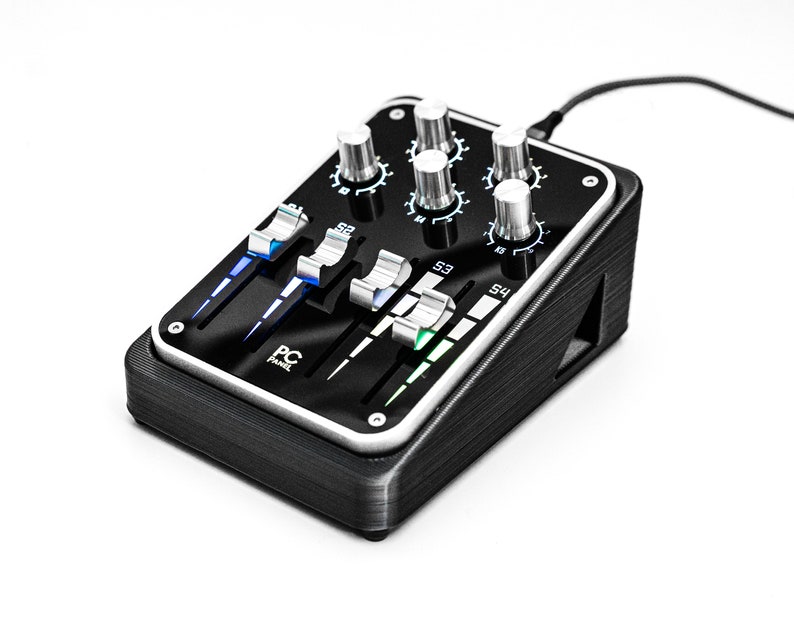 May include: A black audio mixer with four faders and four knobs. The mixer has a silver trim and a black and white logo that says "PC Panel".