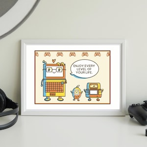 May include: A framed print featuring cartoon characters resembling a laptop, a handheld game console, and a retro game console. The laptop character wears glasses and has a speech bubble that says, "Enjoy every level of your life."