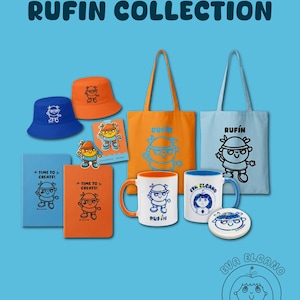 May include: A collection of Ruf&iacute;n-themed merchandise on a blue background. Items include blue and orange bucket hats, tote bags, notebooks, mugs, and a coaster. Each item features a cartoon character and the text "RUF&Iacute;N" or "TIME TO CREATE!"