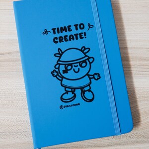 May include: A vibrant blue notebook featuring the words "TIME TO CREATE!" and a black cartoon character. It has a blue elastic band and a ribbon bookmark. The brand name "EVA ELCANO" is printed at the bottom. The notebook is designed for creative use.