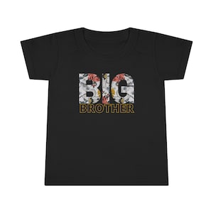 May include: Black t-shirt with a floral design spelling out "BIG BROTHER" in gold letters.