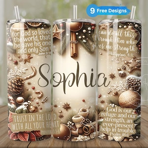May include: A personalized tumbler with a winter-themed design featuring pine cones, ornaments, and a cinnamon stick. The tumbler has a white background with brown and gold accents. The text on the tumbler reads "for God so loved the world, that he gave his one and only Son John 3:16" and "TRUST IN THE LORD WITH ALL YOUR HEART PROVERBS 3:5-6". The tumbler also has the name "Sophia" printed on it.