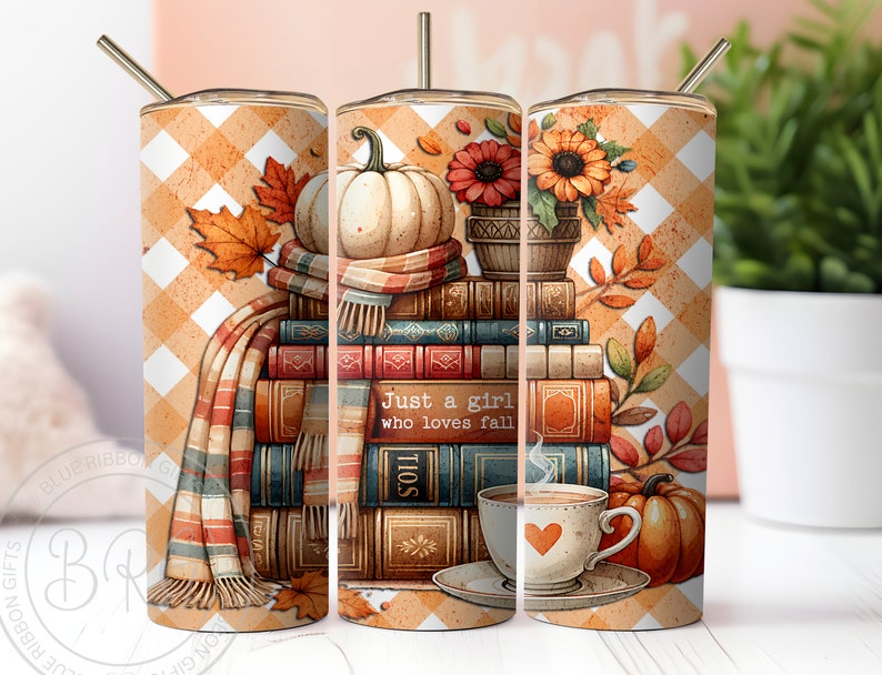 A delightful watercolor illustration featuring a stack of vintage books, surrounded by cream and pastel orange pumpkins, falling autumn leaves, and a cup of hot cocoa. Plaid orange white background. Design is shown on three 20 ounce skinny tumblers.
