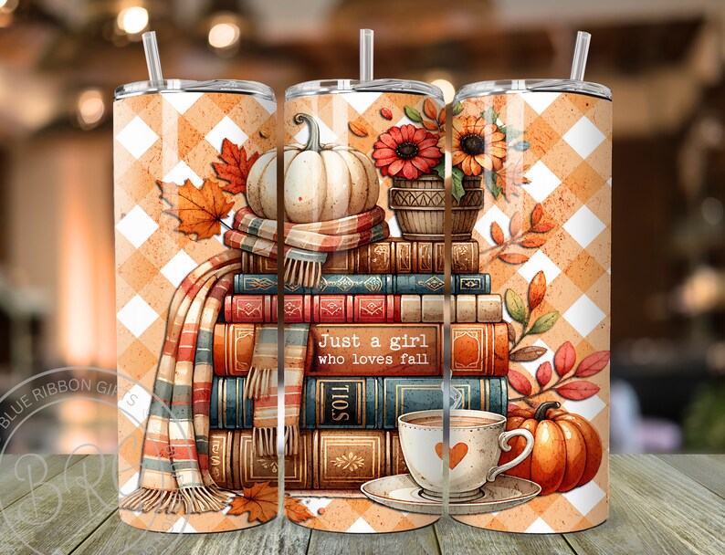 A delightful watercolor illustration featuring a stack of vintage books, surrounded by cream and pastel orange pumpkins, falling autumn leaves, and a cup of hot cocoa. Plaid orange white background. Design is shown on three 20 ounce skinny tumblers.