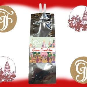 May include: A silver pouch with a straw sticking out of the top. The pouch has a label that says "Magic Kingdom" and "Grand Floridian". The label also has a picture of Cinderella's Castle and other Disney characters.