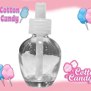 May include: A clear glass bottle with a white pump top and a white dropper. The bottle is filled with a clear liquid. The bottle is labelled "Cotton Candy".