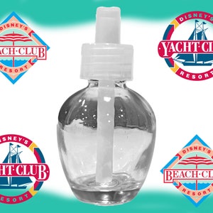 May include: A clear glass bottle with a white plastic pump top. The bottle is shaped like an apple and has a white plastic tube inside. The bottle is surrounded by four logos for Disney's Beach Club and Yacht Club Resorts.