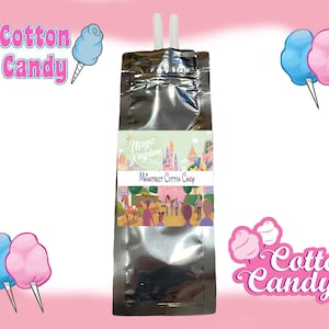 May include: A silver pouch with a label that says "Magic Kingdom Mainstreet Cotton Candy". The pouch has two white straws sticking out of the top. The pouch is surrounded by pink and blue cotton candy.
