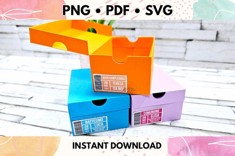 May include: Three colorful gift boxes stacked on top of each other. The top box is orange and says "Buon Compleanno Teresa Da Noi". The middle box is blue and says "Battesimo Luca". The bottom box is purple and says "Comunione Elisa".