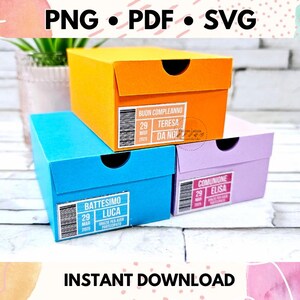 May include: Three shoe boxes stacked on top of each other. The top box is orange and says "BUON COMPLEANNO TERESA DA NO" The middle box is blue and says "BATTESIMO LUCA". The bottom box is purple and says "COMUNIONE ELISA".