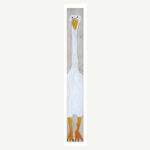 May include: A white goose with a long neck and orange feet is painted on a wooden panel. The goose has a yellow beak and black eyes.