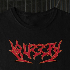 May include: Black t-shirt with a red and orange graphic of the word "BURIAL" in a stylised font.