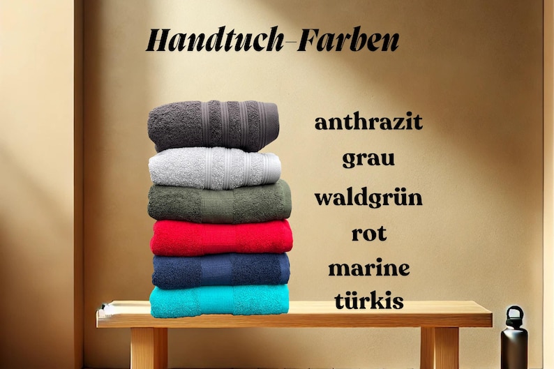 May include: A stack of towels in various colors, including gray, green, red, blue, and turquoise. The towels are labeled with the German words for each color: anthrazit, grau, waldgr&uuml;n, rot, marine, and t&uuml;rkis.
