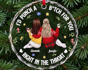 May include: A round, clear acrylic Christmas ornament featuring two illustrated figures sitting side-by-side. The text reads, "I'D PUNCH A B*TCH FOR YOU RIGHT IN THE THROAT," with the names "Elizabeth" and "Jennifer" printed below the figures.