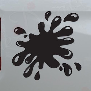 May include: Black vinyl decal of a paint splatter on a white truck. The decal is on the back of the truck, near the taillight. The decal is a popular choice for car enthusiasts and adds a unique touch to any vehicle.