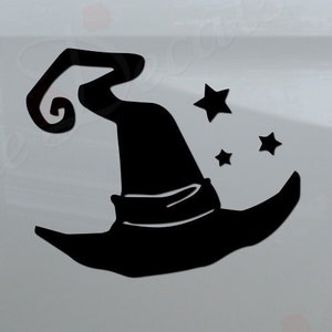 May include: Black witch hat with a curled brim and three stars on a white truck tailgate. The truck has a black bumper with the words "Rosie Decals" in black lettering with red roses.