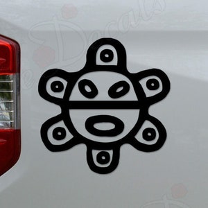 May include: Black and white vinyl sticker of the Boriken symbol, a stylized sun with a face, on the back of a white pickup truck.