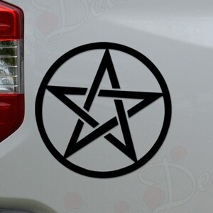 May include: Black pentagram sticker on a white truck tailgate.