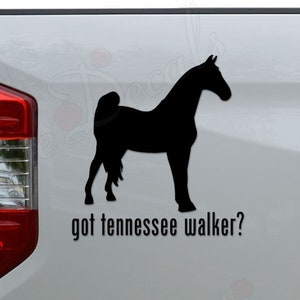 May include: Black silhouette of a Tennessee Walker horse on a white truck tailgate with the text "got tennessee walker?"