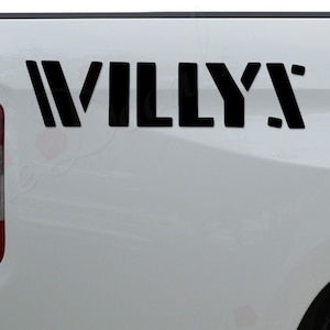 May include: A white pickup truck with a black "WILLY'S" decal on the back.