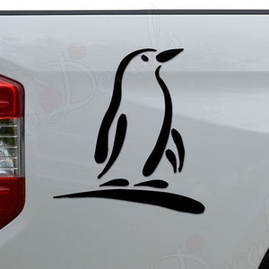 May include: Black silhouette of a penguin on a white truck tailgate. The penguin is facing right and has a simple design.