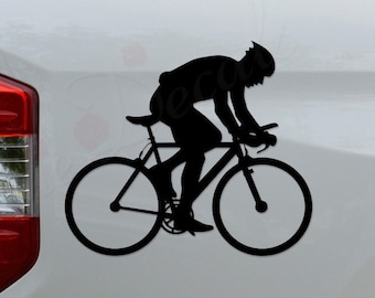 May include: Black silhouette of a cyclist riding a bicycle on a white truck tailgate. The cyclist is wearing a helmet and is in a racing position.
